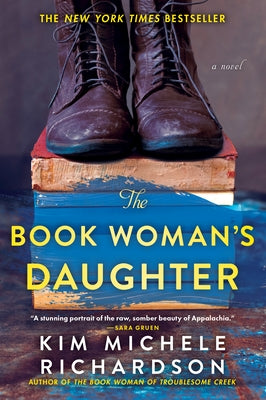 Paperback copy of The Book Woman's Daughter by Sourcebooks Landmark showing the book cover with title and author text.