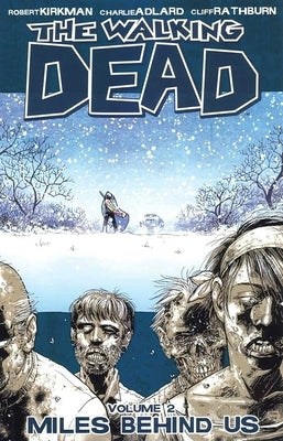 Paperback of Walking Dead Volume 2: Miles Behind Us by Image Comics, featuring comic book cover art and character illustrations.