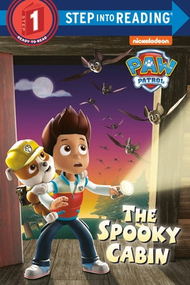 Paperback of The Spooky Cabin by Paw Patrol featuring a colorful cover with characters and a spooky cabin scene.