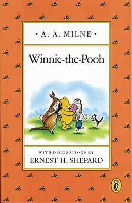 Paperback Winnie-the-Pooh book by Puffin Books featuring a colorful cover illustration of Winnie-the-Pooh sitting with honey.
