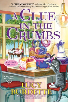 Paperback of "A Clue in the Crumbs" mystery novel by Crooked Lane Books, showing the book cover with title and author.