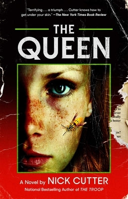 Paperback copy of "The Queen" by Gallery Books, showing the book cover with title and author text.