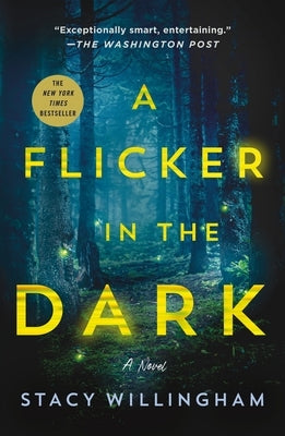 Paperback copy of A Flicker in the Dark by Minotaur Books, featuring the book cover with title and author details.