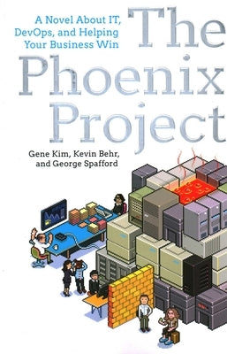 Paperback of The Phoenix Project novel about IT, DevOps, and business success by It Revolution, featuring a cover with a fiery phoenix.