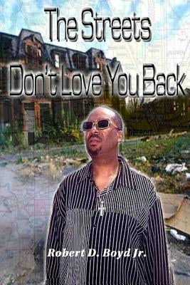 Paperback of "The Streets Don't Love You Back" by Boyd Publishing, showing the book cover with urban street art design.