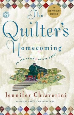 Paperback of The Quilter's Homecoming novel by Simon & Schuster, featuring a cozy quilt-themed cover design.