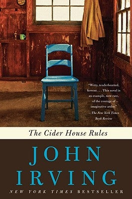 Paperback copy of "The Cider House Rules" by Ballantine Books, featuring a close-up of the book cover.