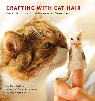 Paperback book titled "Crafting with Cat Hair" by Quirk Books featuring a colorful cover with cat illustrations and craft supplies.
