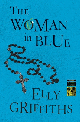 Paperback copy of The Woman in Blue novel by Mariner Books with a blue cover and illustrated front cover art.