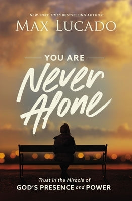 Paperback book titled "You Are Never Alone" by Thomas Nelson, featuring a serene cover design about God's presence and power.