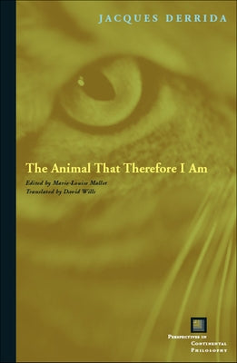 Paperback copy of "The Animal That Therefore I Am" by Fordham University Press, featuring a book cover with animal imagery.