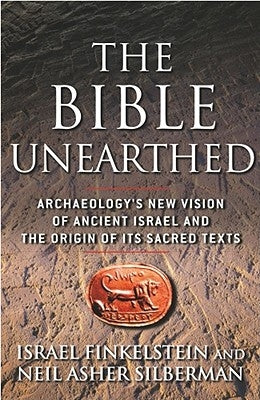 Paperback copy of The Bible Unearthed by Free Press, featuring the book cover with archaeological illustrations and text.