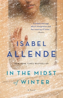 Paperback copy of "In the Midst of Winter" novel by Atria Books, showing the book cover with winter-themed artwork.