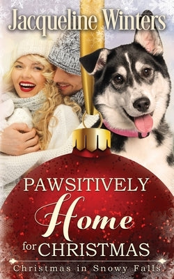 Paperback book titled "Pawsitively Home for Christmas" by Jackie M. Wallick, featuring a festive holiday cover with a small town scene.