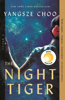 Paperback of The Night Tiger novel by Flatiron Books, featuring the book cover with dark and intricate artwork.