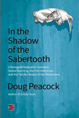 Paperback book titled "In the Shadow of the Sabertooth" by AK Press, featuring a cover illustration of Pleistocene beasts and early American history.