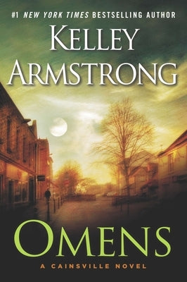 Paperback copy of "Omens" by Dutton, with a close-up of the book cover featuring dark and mysterious artwork.