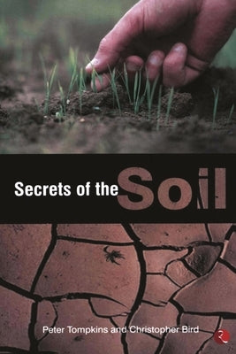 Paperback copy of "Secrets of the Soil" by Rupa, showing the book cover with soil-related imagery and title text.