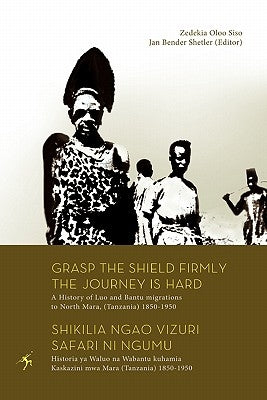 Paperback book titled "Grasp the Shield Firmly the Journey is Hard" by Mkuki na Nyota Publishers, covering Luo and Bantu migrations in Tanzania.