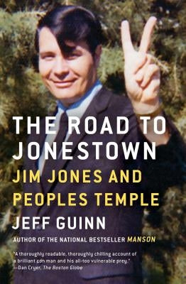 Paperback book titled "The Road to Jonestown" by Simon & Schuster, featuring a cover with images related to Jim Jones and Peoples Temple.