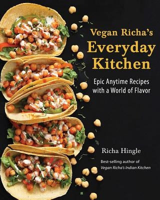 Paperback cookbook titled Vegan Richa's Everyday Kitchen by Vegan Heritage Press, featuring colorful recipe pages and vibrant dish photos.