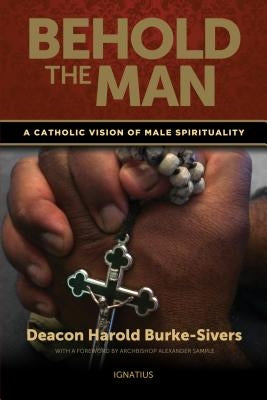 Paperback book titled "Behold the Man" by Ignatius Press, featuring a Catholic perspective on male spirituality.