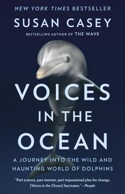 Paperback book titled "Voices in the Ocean" by Anchor Books, featuring a cover image with dolphins swimming underwater.