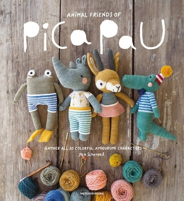 Colorful amigurumi animal characters from Animal Friends of Pica Pau in a paperback book by Meteoor Books, shown together in a group.