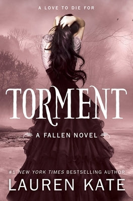 Paperback copy of "Torment" by Ember, showing the book's cover with dark artwork and title text.