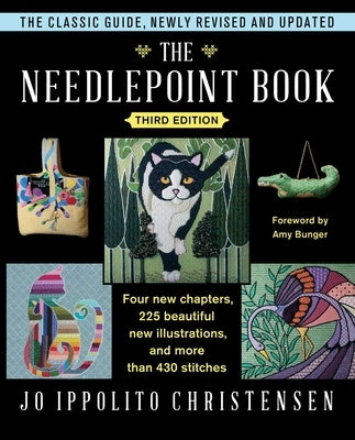 Open copy of The Needlepoint Book by Touchstone Books showing detailed needlepoint patterns and colorful embroidery designs.