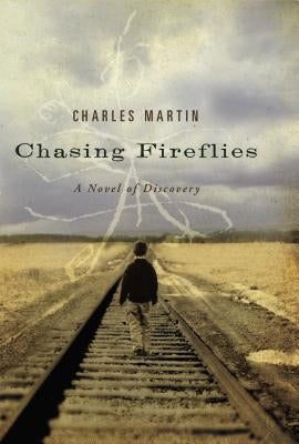 Paperback copy of "Chasing Fireflies: A Novel of Discovery" by Thomas Nelson, with book cover featuring colorful fireflies and a nighttime scene.
