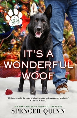 Paperback copy of "It's a Wonderful Woof: A Chet & Bernie Mystery" by Forge, featuring the book cover with dog illustration.
