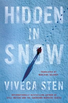 Paperback of Hidden in Snow by Amazon Crossing showing the book cover with snowy landscape and title text.
