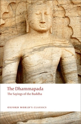 Paperback copy of The Dhammapada: The Sayings of the Buddha by Oxford University Press, USA, featuring a close-up of the book cover.