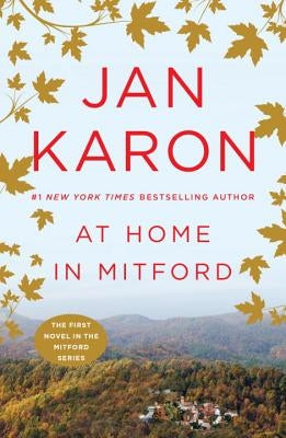 Paperback copy of "At Home in Mitford" novel by G.P. Putnam's Sons, featuring a cover with warm, inviting design.
