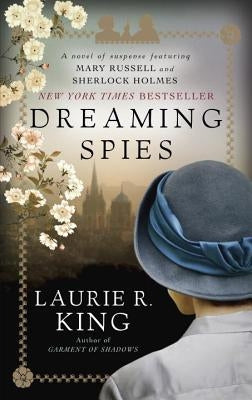 Paperback of Dreaming Spies by Bantam featuring Mary Russell and Sherlock Holmes, with a cover illustration of a mysterious scene.