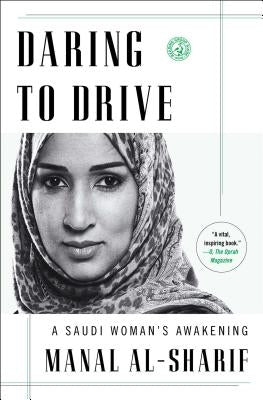 Paperback of "Daring to Drive: A Saudi Woman's Awakening" by Simon & Schuster, showing the book cover with title and author.