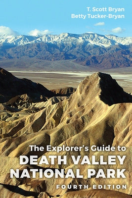 Paperback copy of The Explorer's Guide to Death Valley National Park, Fourth Edition by University Press of Colorado, with desert landscape on cover.
