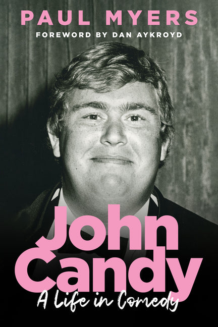 Paperback book titled "John Candy: A Life in Comedy" by House of Anansi Press, cover with a portrait of John Candy.
