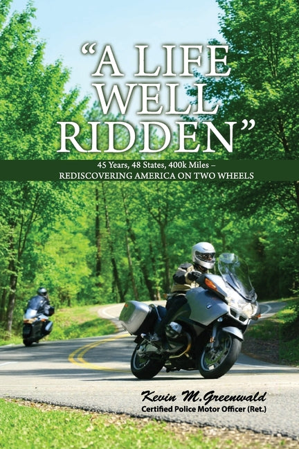Paperback titled "A Life Well Ridden" by Kevin M. Greenwald, featuring a motorcycle journey across America with scenic images.
