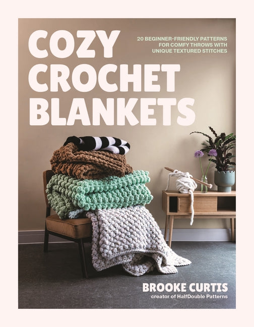 Paperback book titled "Cozy Crochet Blankets" by Page Street Publishing, showing colorful textured crochet blanket patterns on the cover.