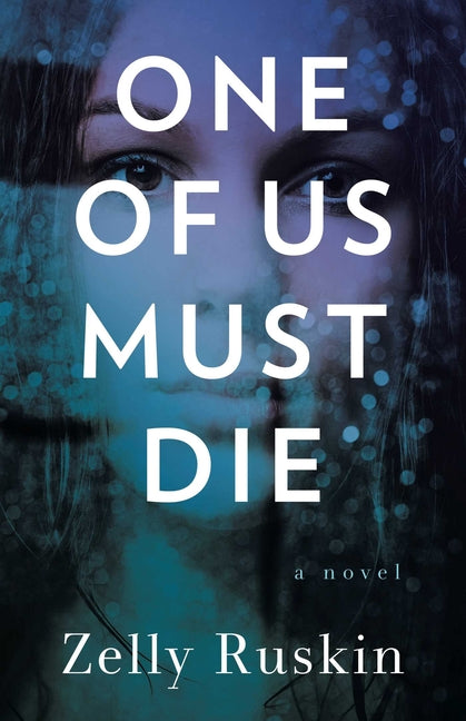 Paperback of "One of Us Must Die" by She Writes Press, featuring the book cover with title and author details.