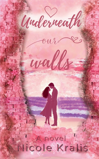Paperback copy of "Underneath Our Walls" by Nicole Kralis, featuring the book cover with artistic design and title text.