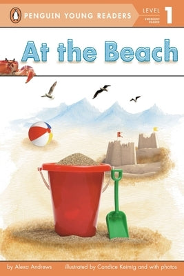 Paperback copy of "At the Beach" by Penguin Young Readers Group, showing the book cover with beach scene illustration.