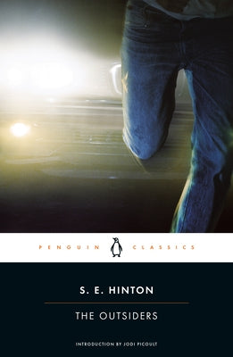 Paperback of The Outsiders by Penguin Classics showing the book cover with title and author on a plain background.