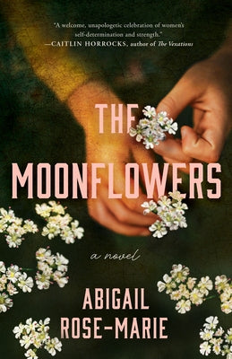 Paperback of The Moonflowers novel by Lake Union Publishing, showing the book cover with floral artwork and title.