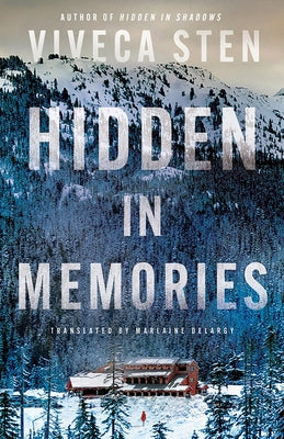Paperback of "Hidden in Memories" by Amazon Crossing, showing the book cover with a soft-focus background.