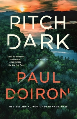 Paperback copy of Pitch Dark novel by Minotaur Books, featuring dark, atmospheric cover art with a mysterious design.