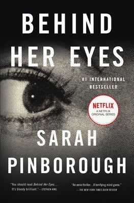 Paperback of Behind Her Eyes, a suspenseful psychological thriller by Flatiron Books, featuring a dark, mysterious cover design.