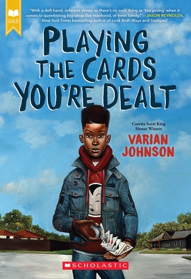 Paperback of "Playing the Cards You're Dealt" by Scholastic Paperbacks, featuring the book cover with colorful title and author name.